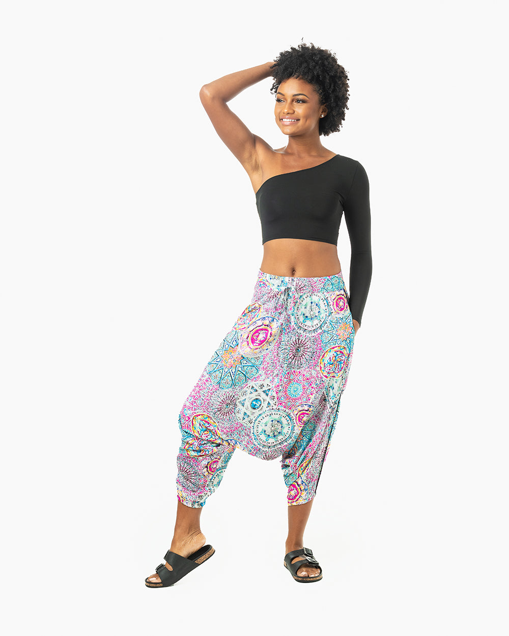 Black model in purple galactic print harem pants posing confidently #color_purple galactic