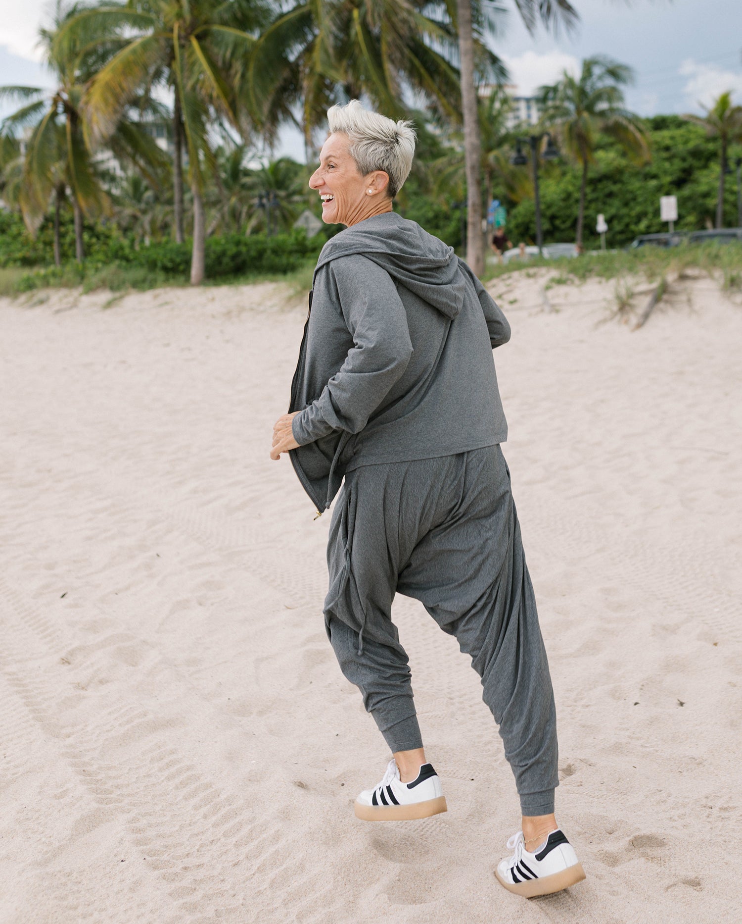 Woman in parachute pants and oversized organic hoodie #color_grey