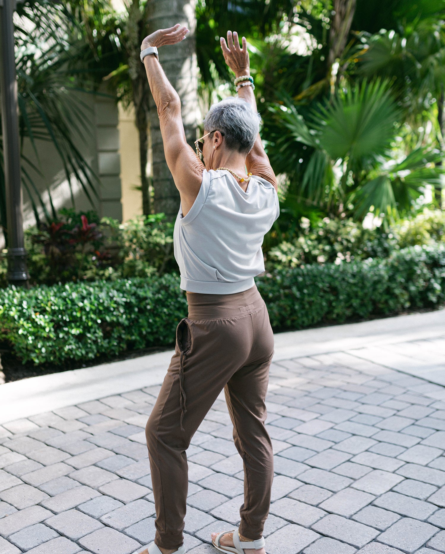 Woman stretching in black yoga pants during morning workout