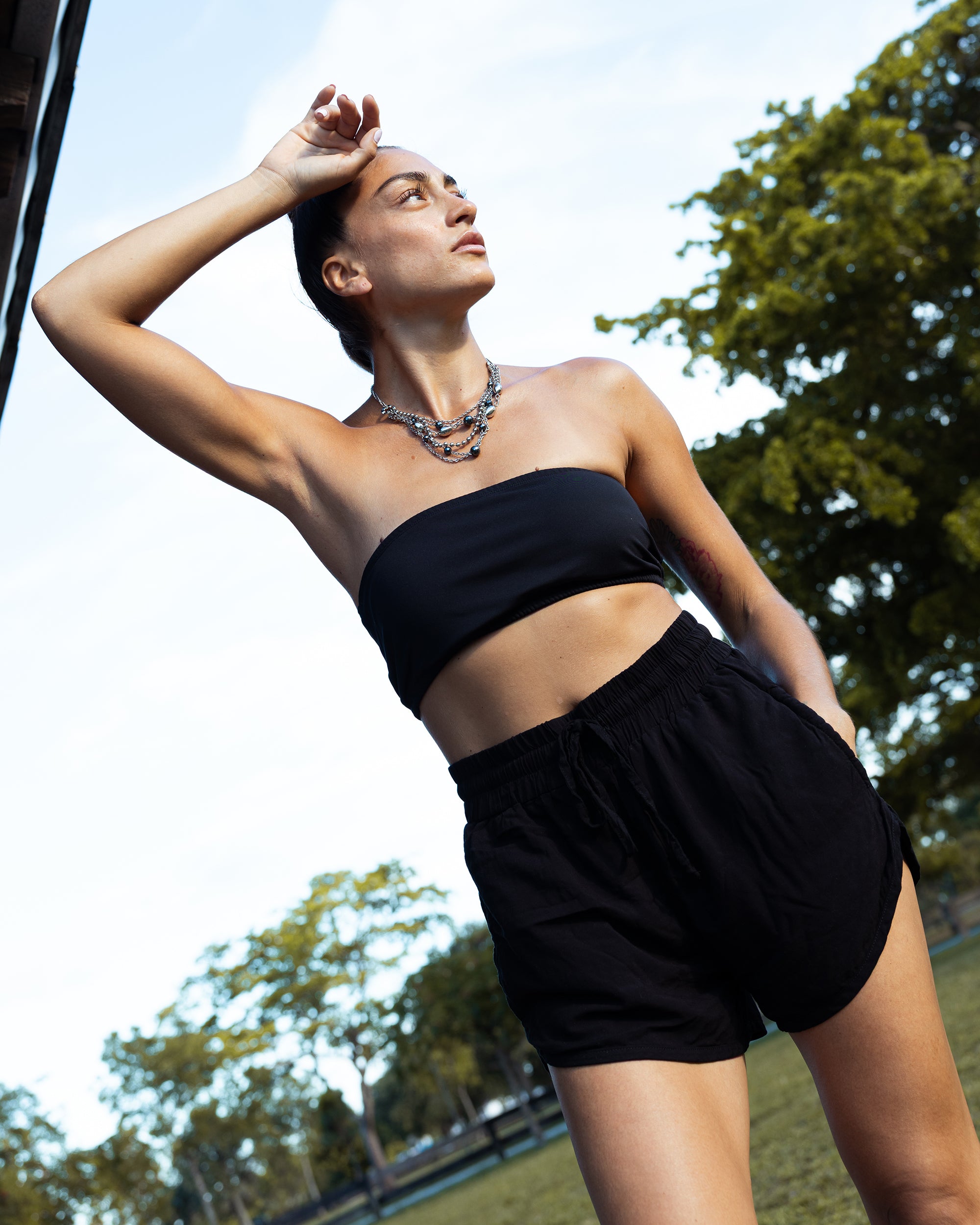 woman in yoga black harem shorts #color_black
