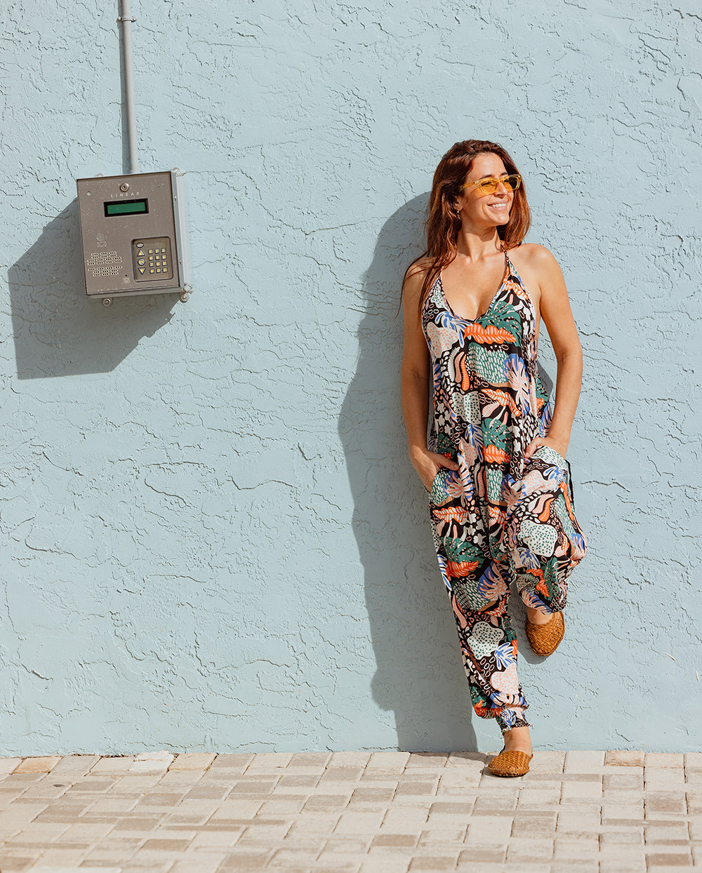 Model in lionfish print jumpsuit chic summer outfit #color_lionfish