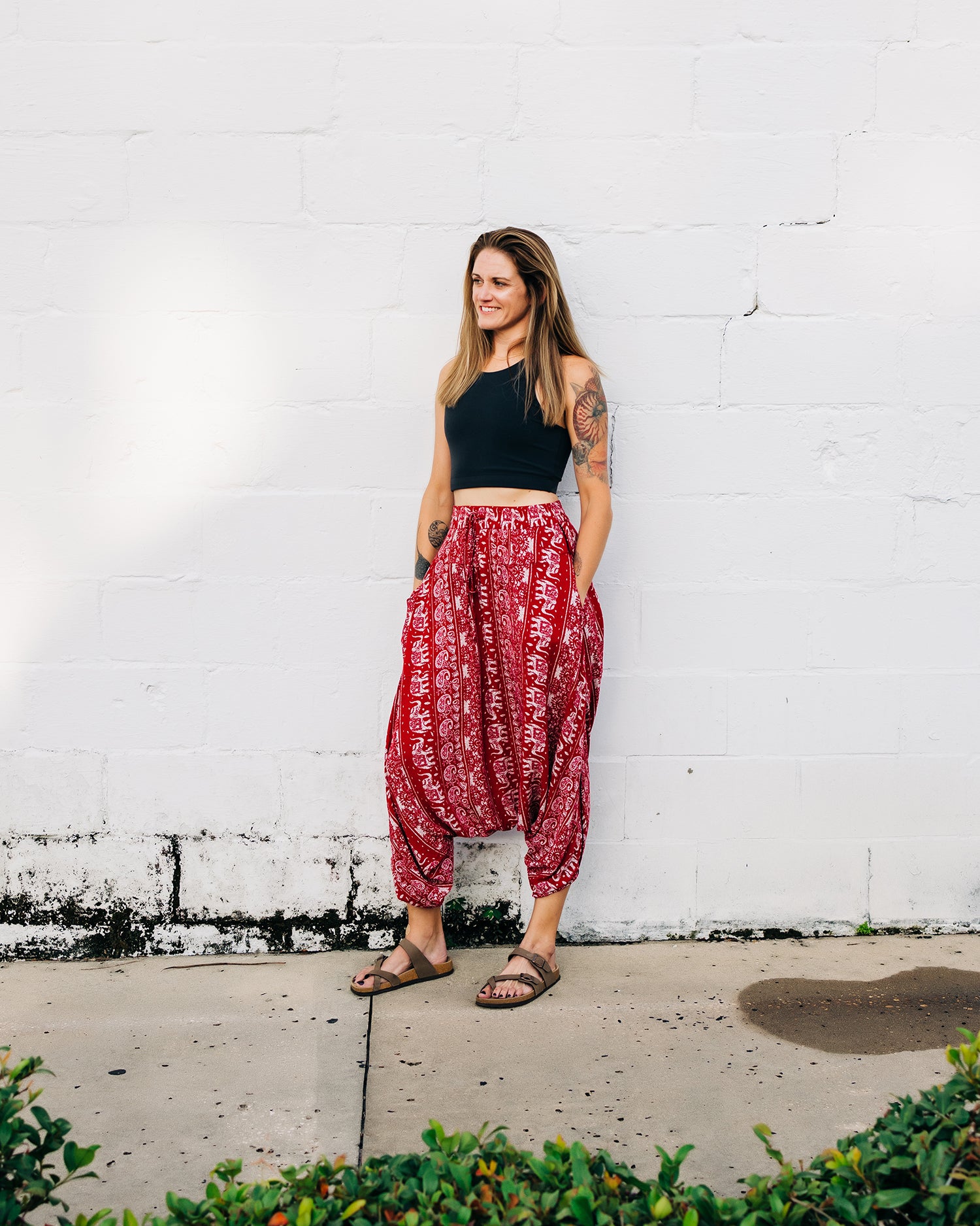 Woman standing outdoors in red lotus yoga pants #color_red lotus