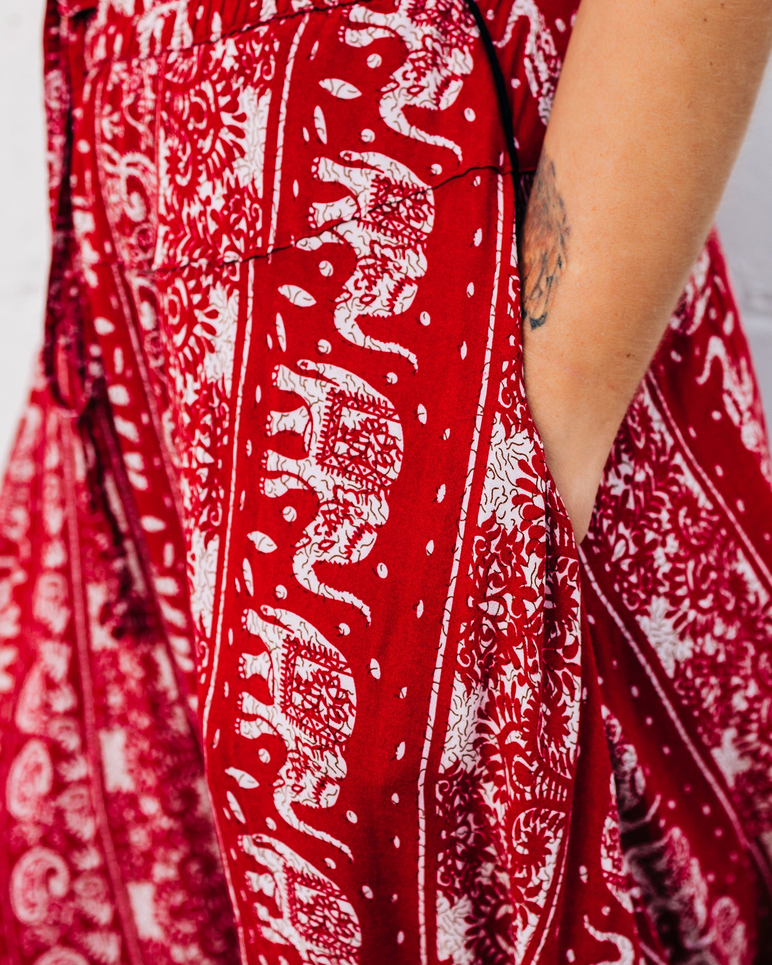Close-up of red lotus macro yoga pants with hands in pockets #color_red lotus