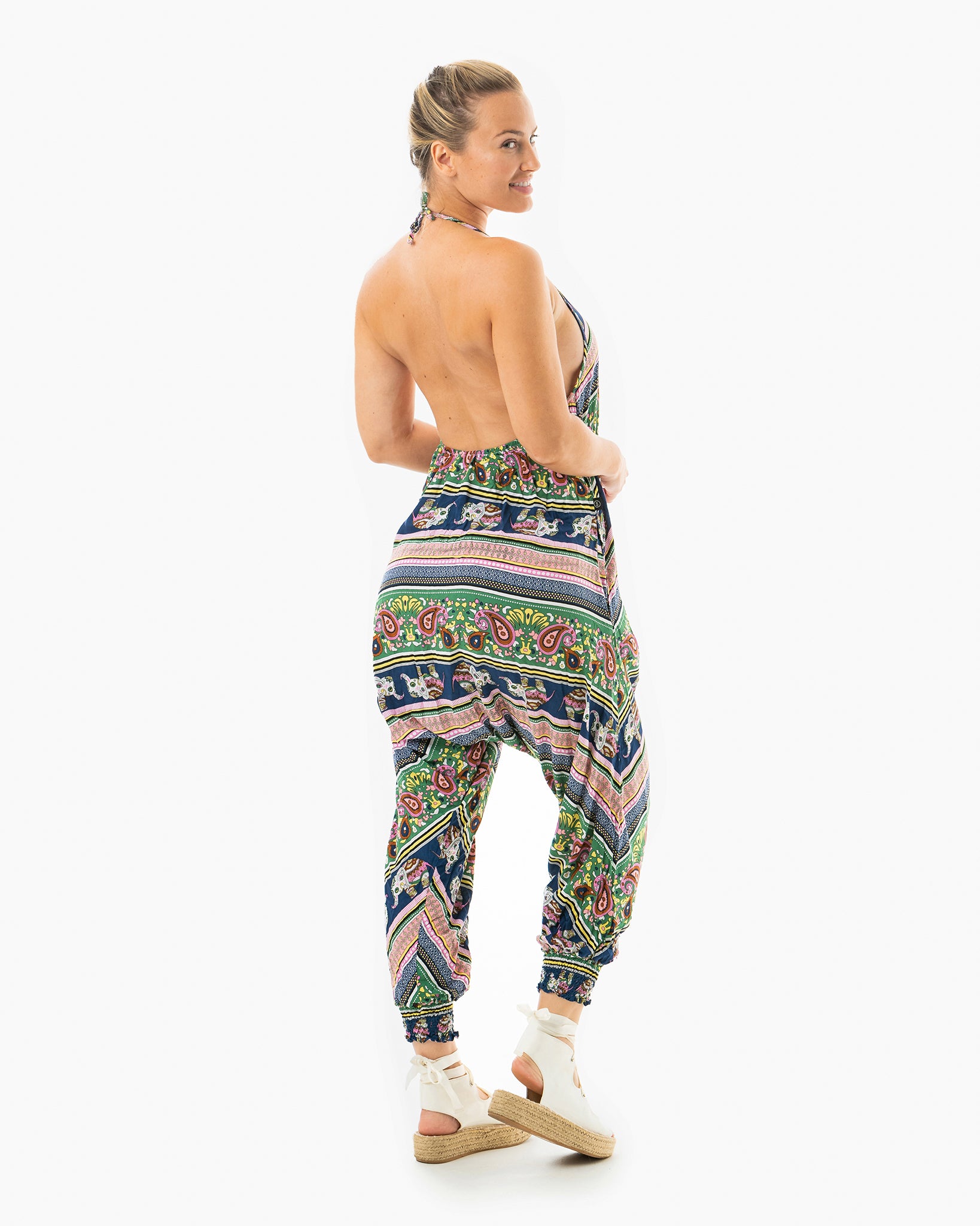 Back view of woman wearing pink elephant print harem pants #color_pink elephant