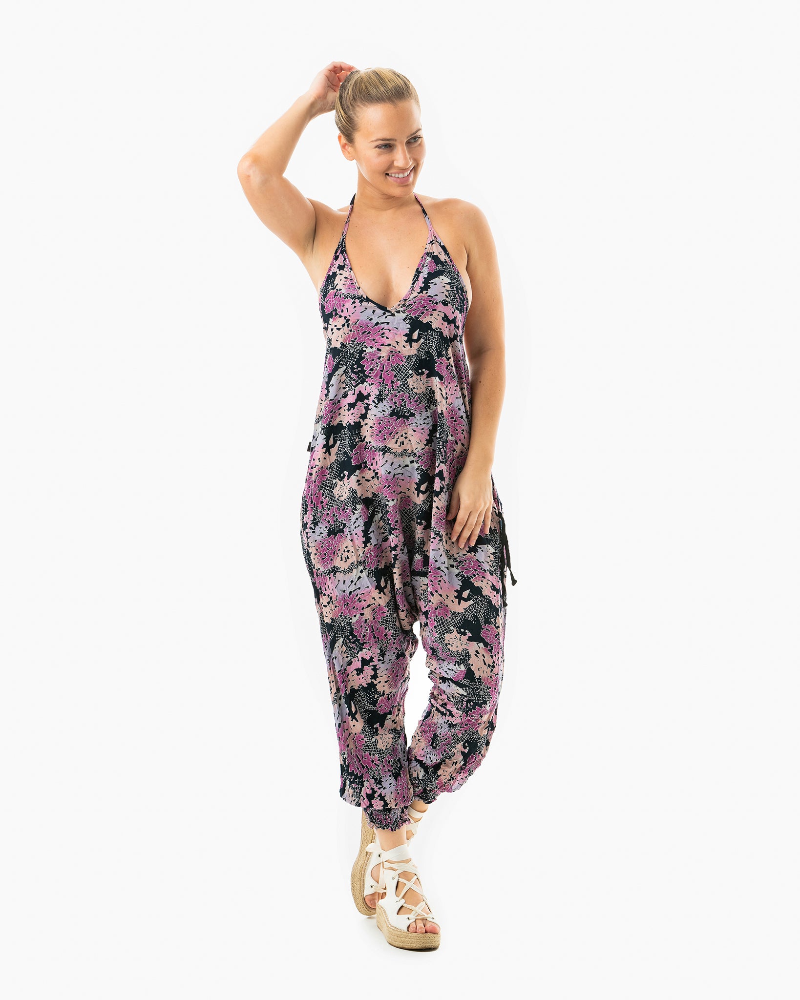 Standing woman in digital rainbow print jumpsuit #color_digital rainbow