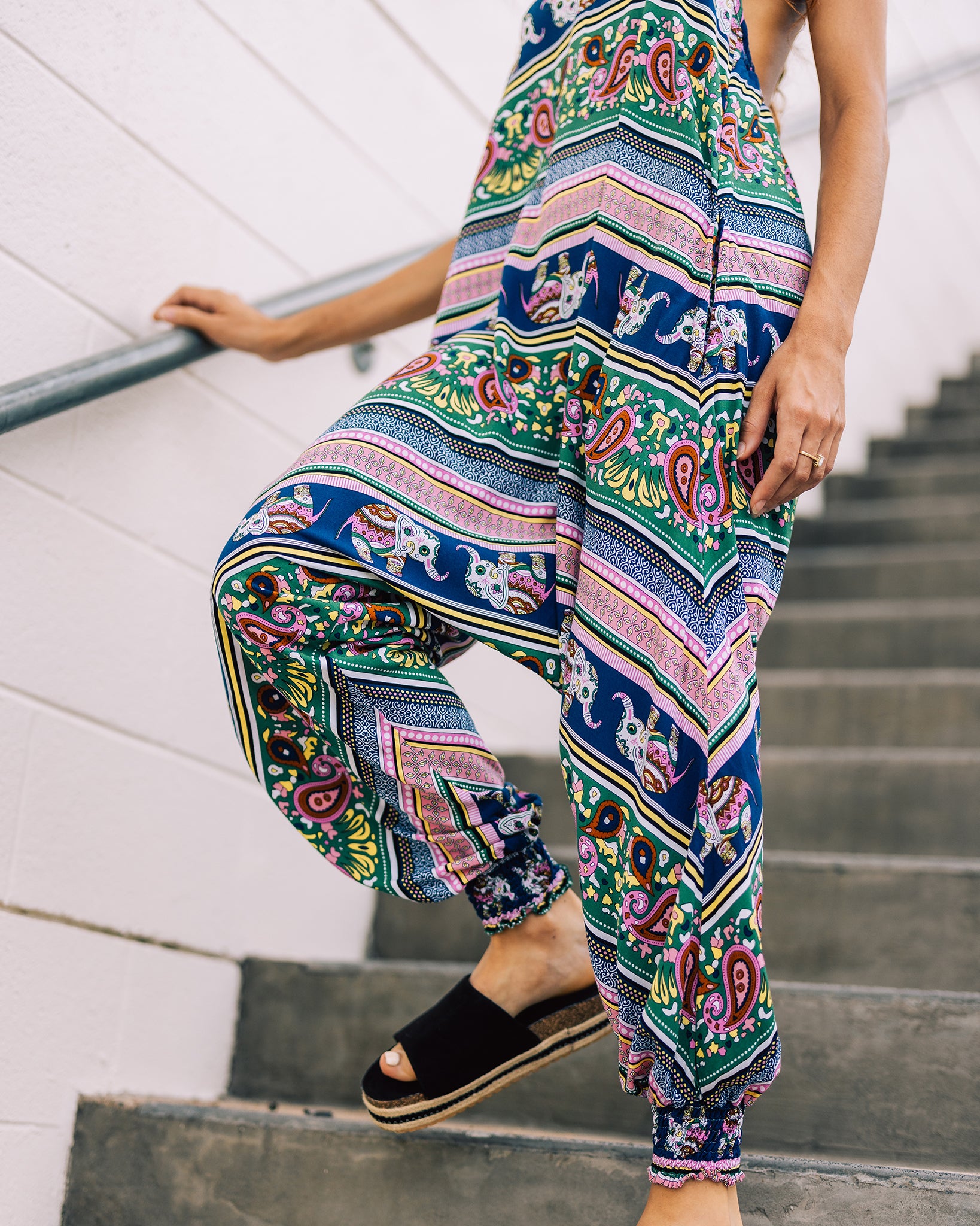 Another view on stairs of pink elephant print Savannah Flair jumpsuit #color_pink elephant