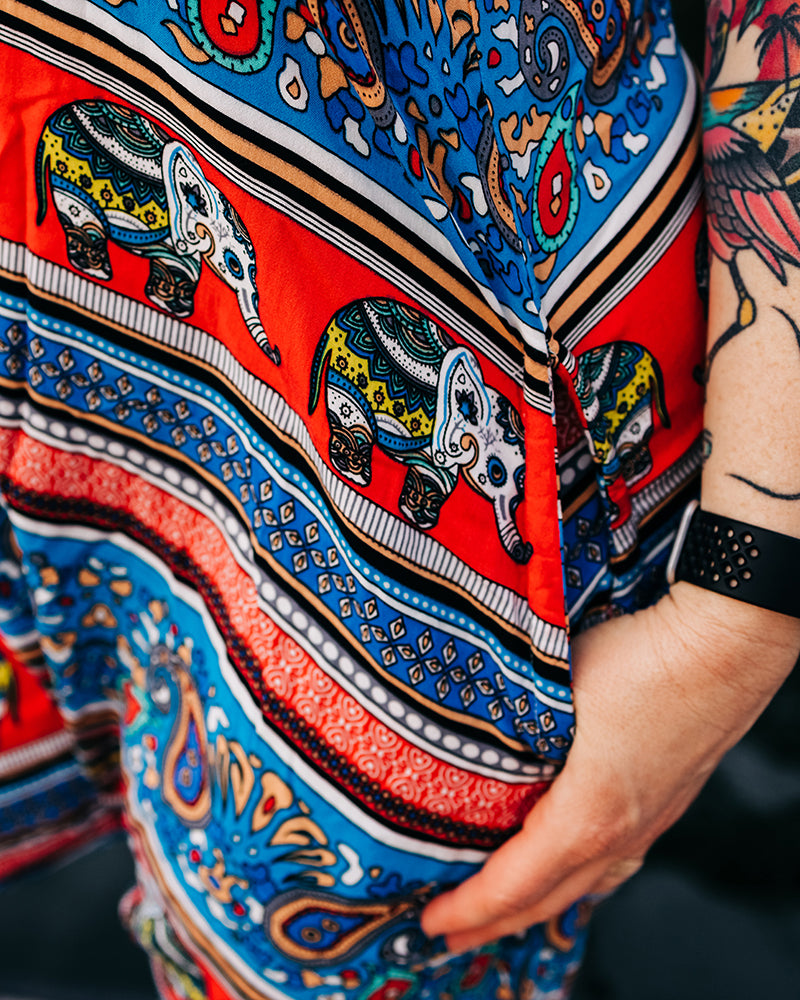 Close-up of elephant print on cotton romper with pockets #color_red elephant