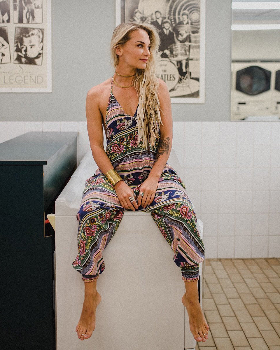 Woman sitting in pink elephant print jumpsuit #color_pink elephant