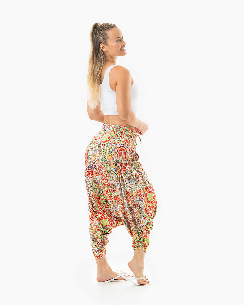 Model in studio wearing red galactic MC Hammer-style pants #color_red galactic
