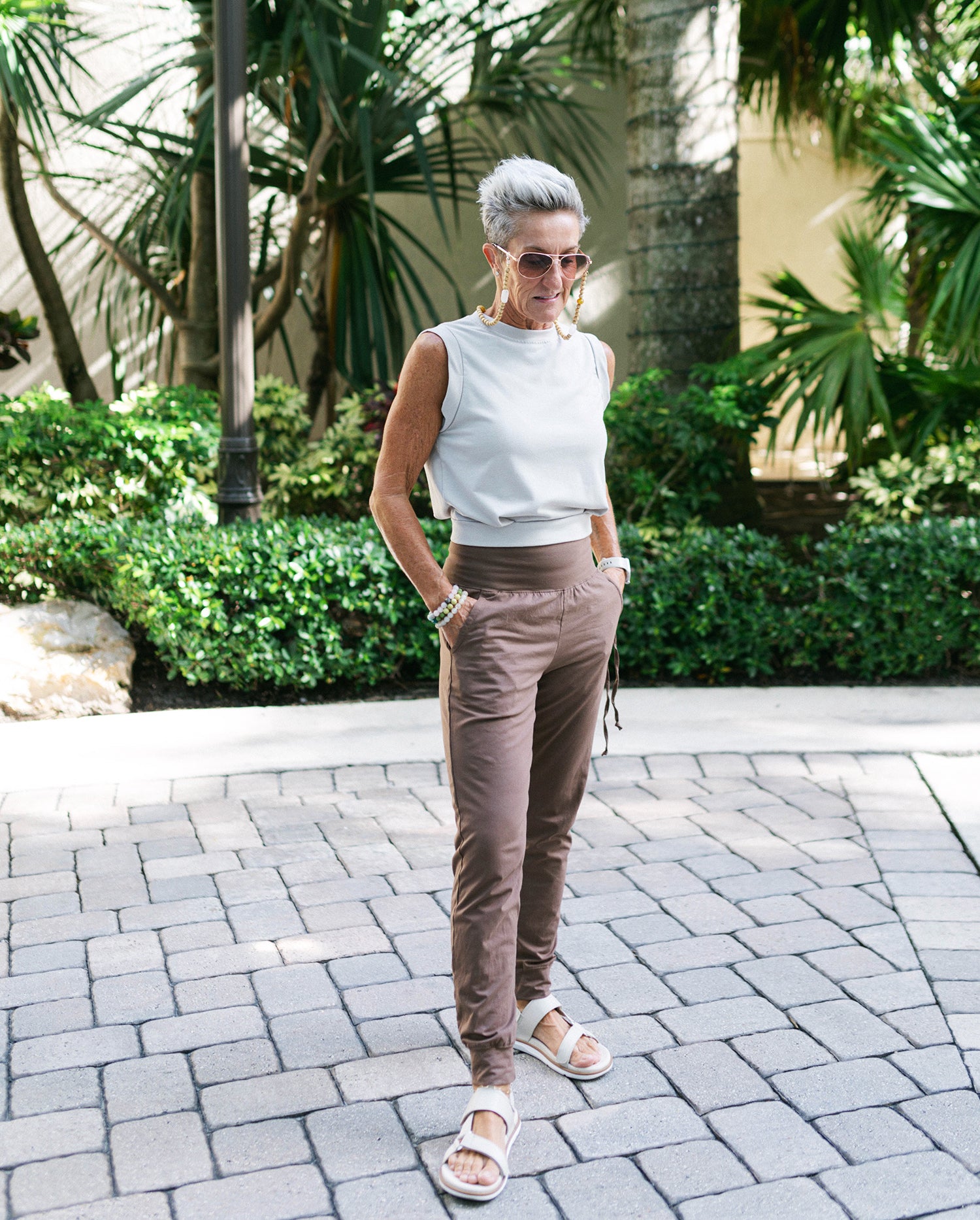 Man wearing tapered joggers and sneakers post-workout#color_walnut