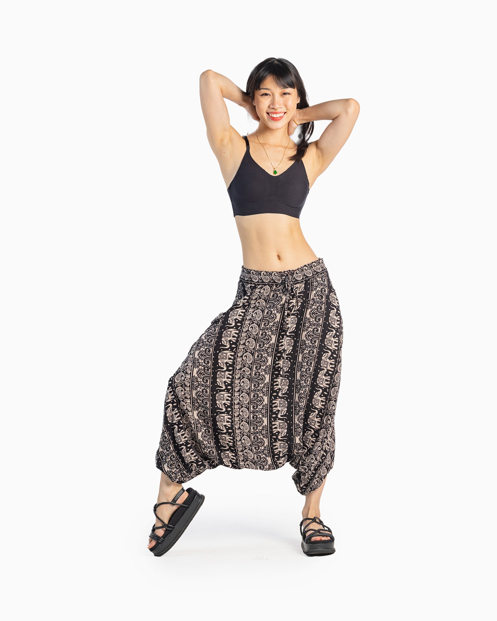 asian model wearing black lotus-pattern harem pants with relaxed look #color_black lotus