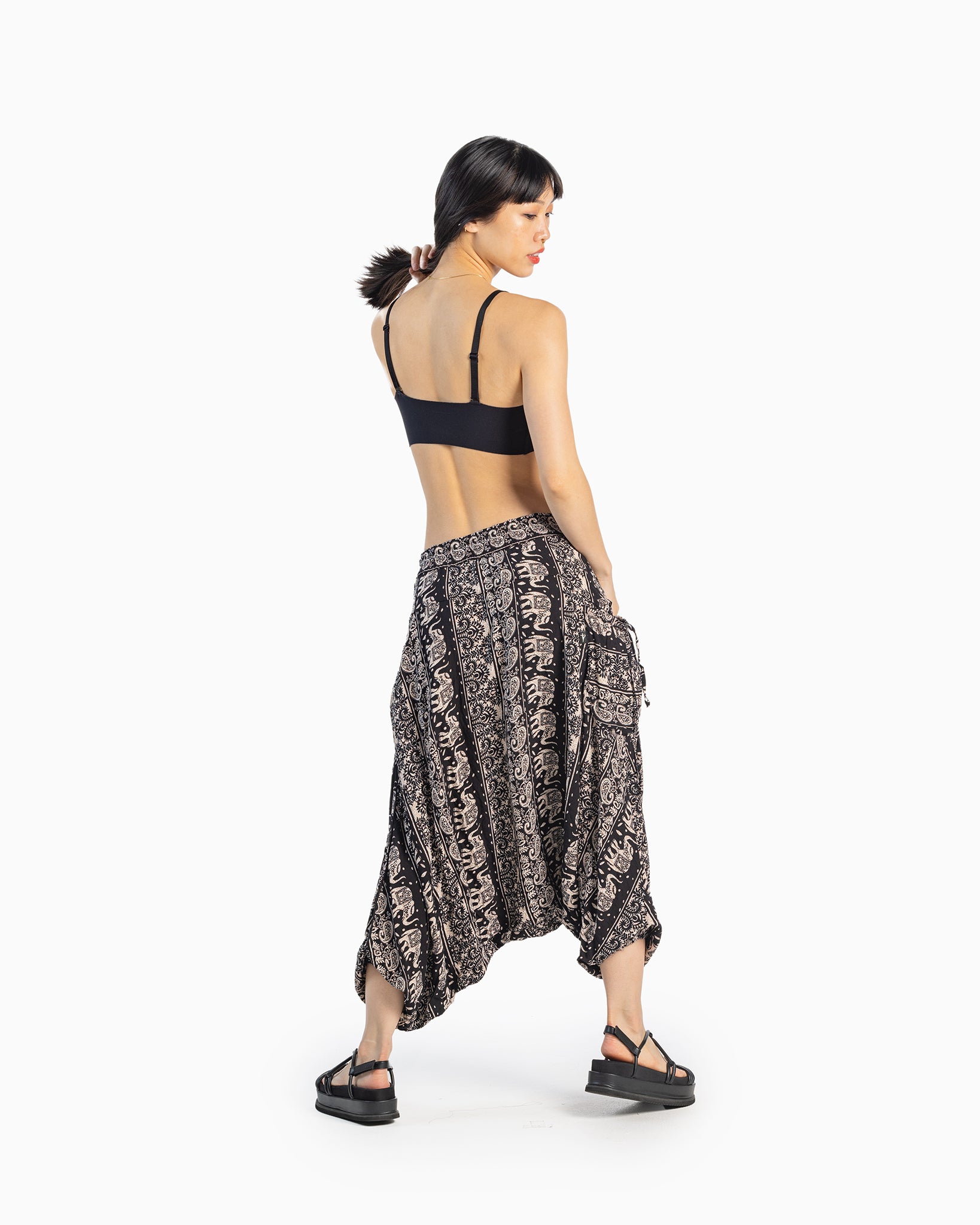 asian model posing in wide-leg pants #color_black lotus