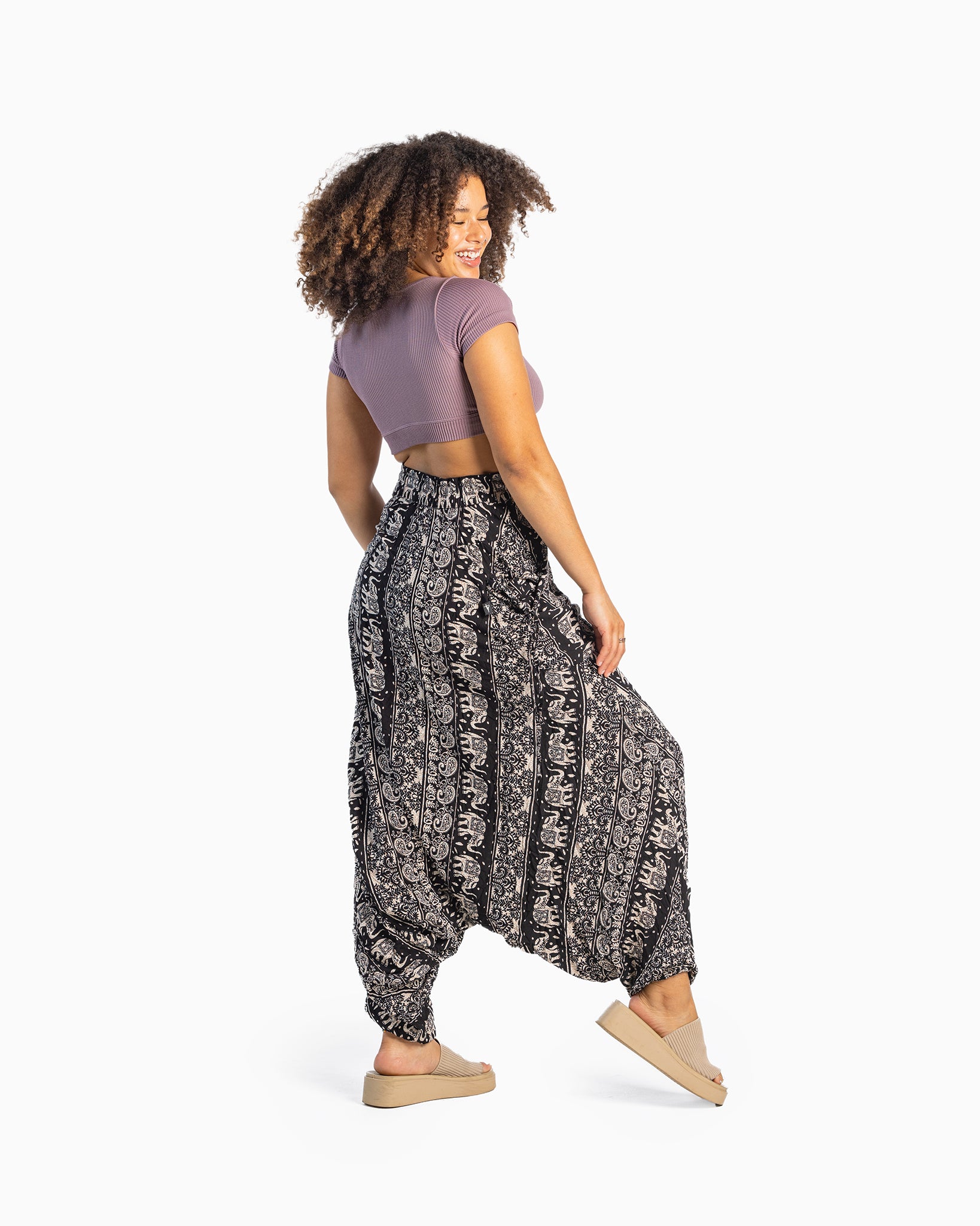 black model wearing flowy black harem pants #color_black lotus