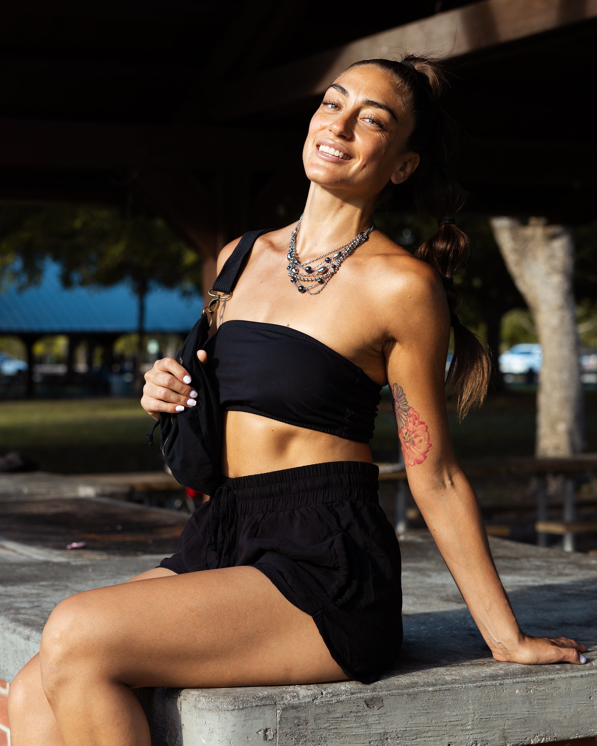 woman in yoga black harem shorts #color_black
