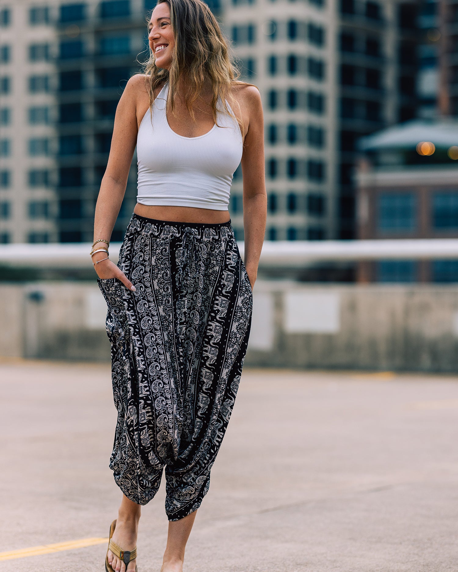 woman standing in monk pants on rooftop #color_black lotus