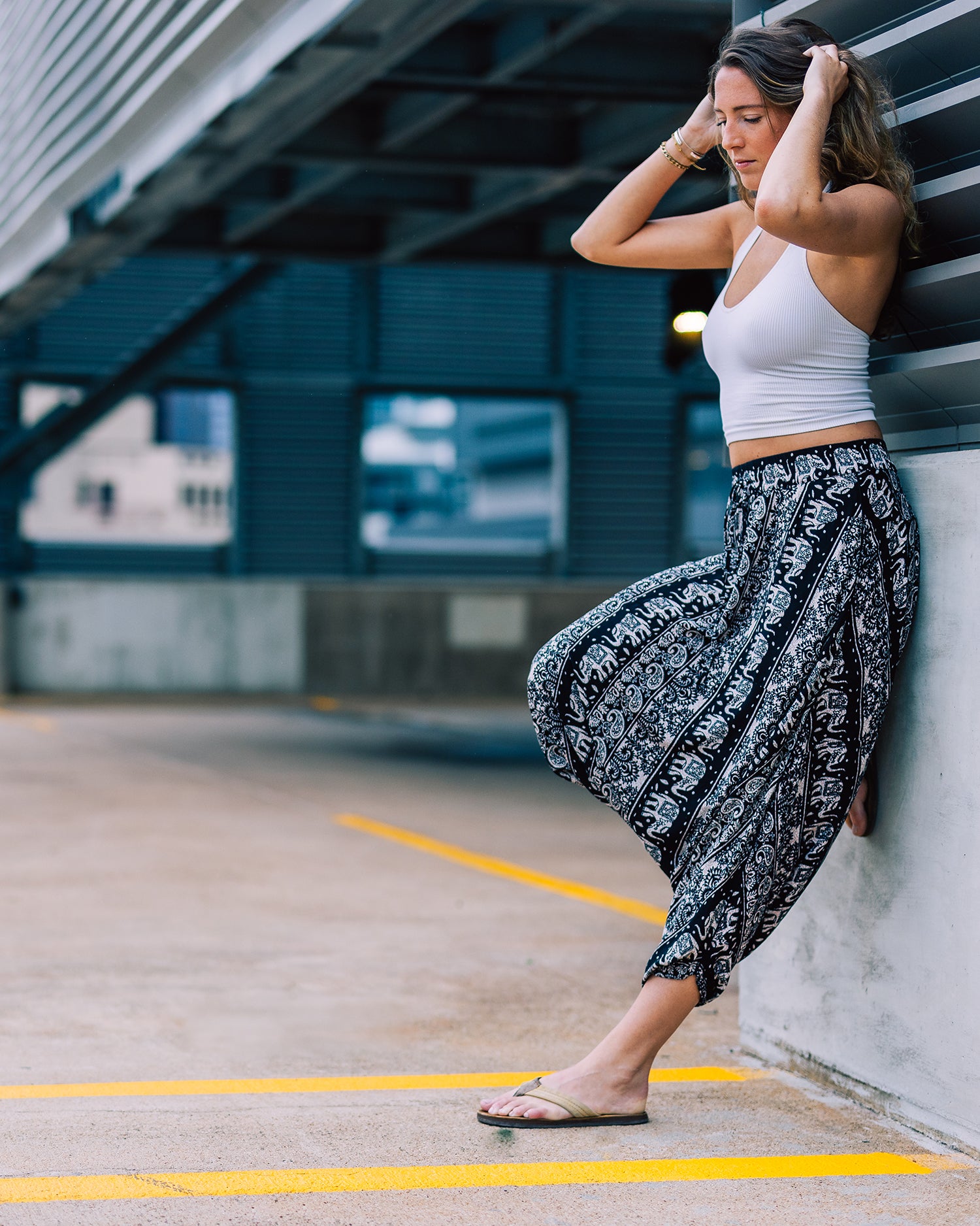 urban woman modeling black dance pants with white tank #color_black lotus