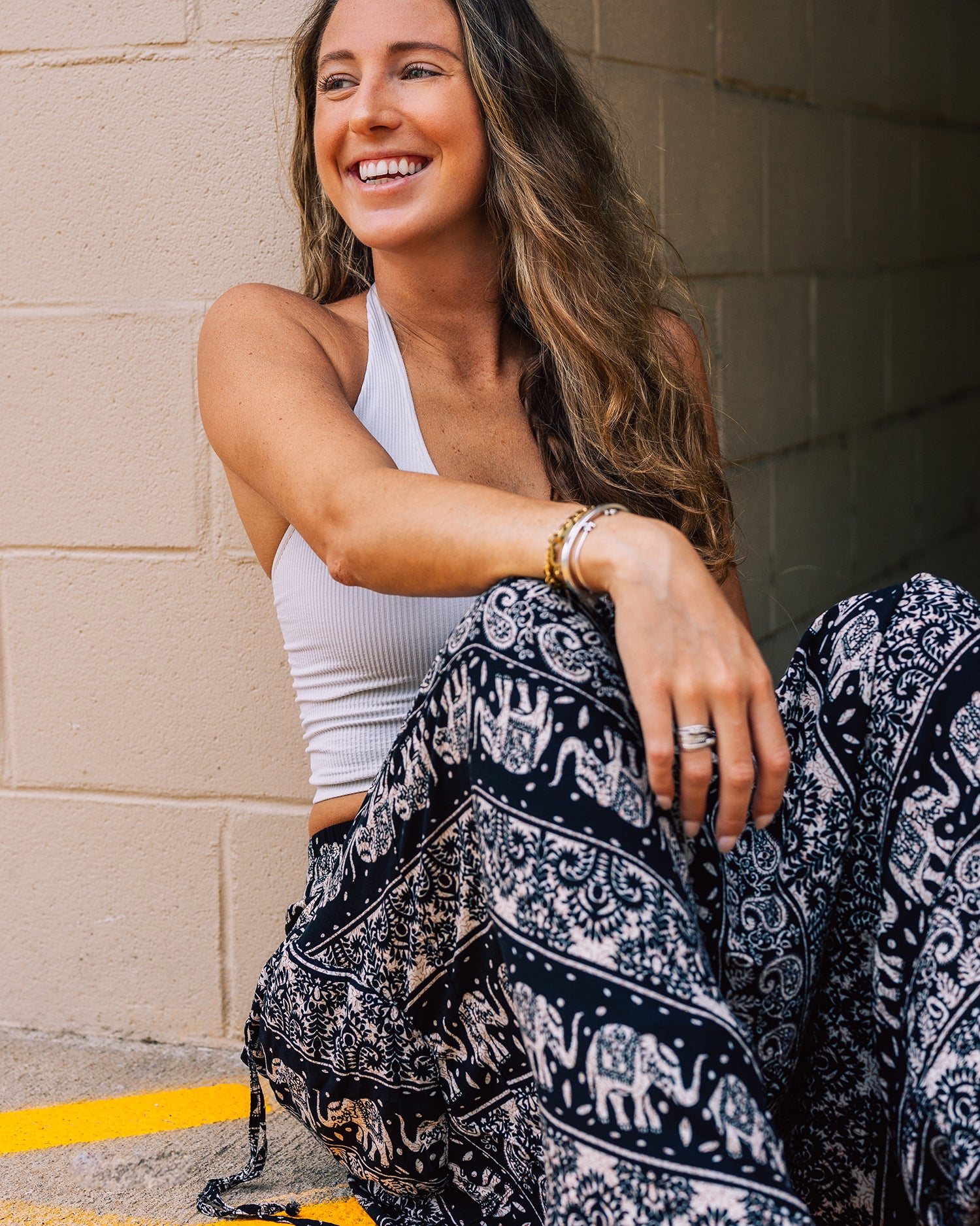 smiling model wearing cozy pants #color_black lotus